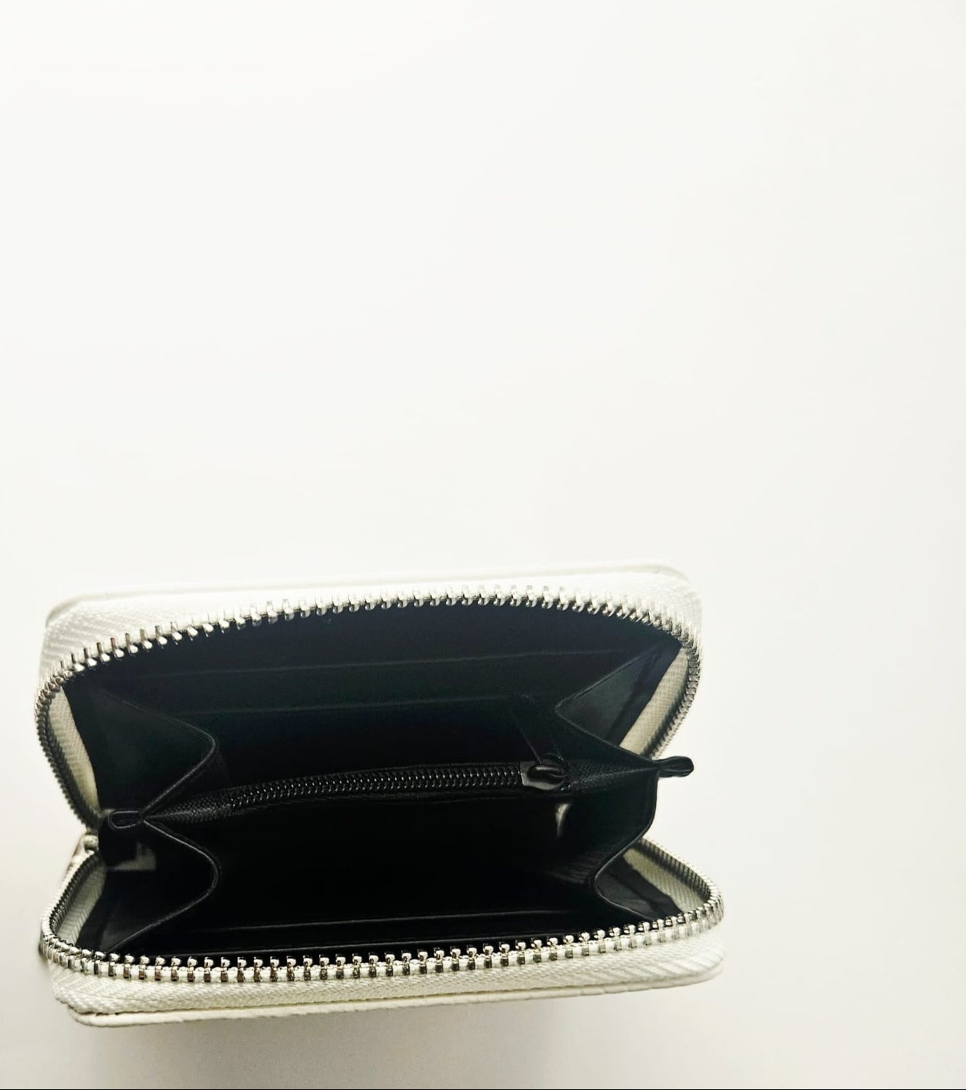 Open wallet with a black interior on a white background