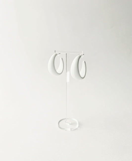 Pair of white hoop earrings on a light gray background
