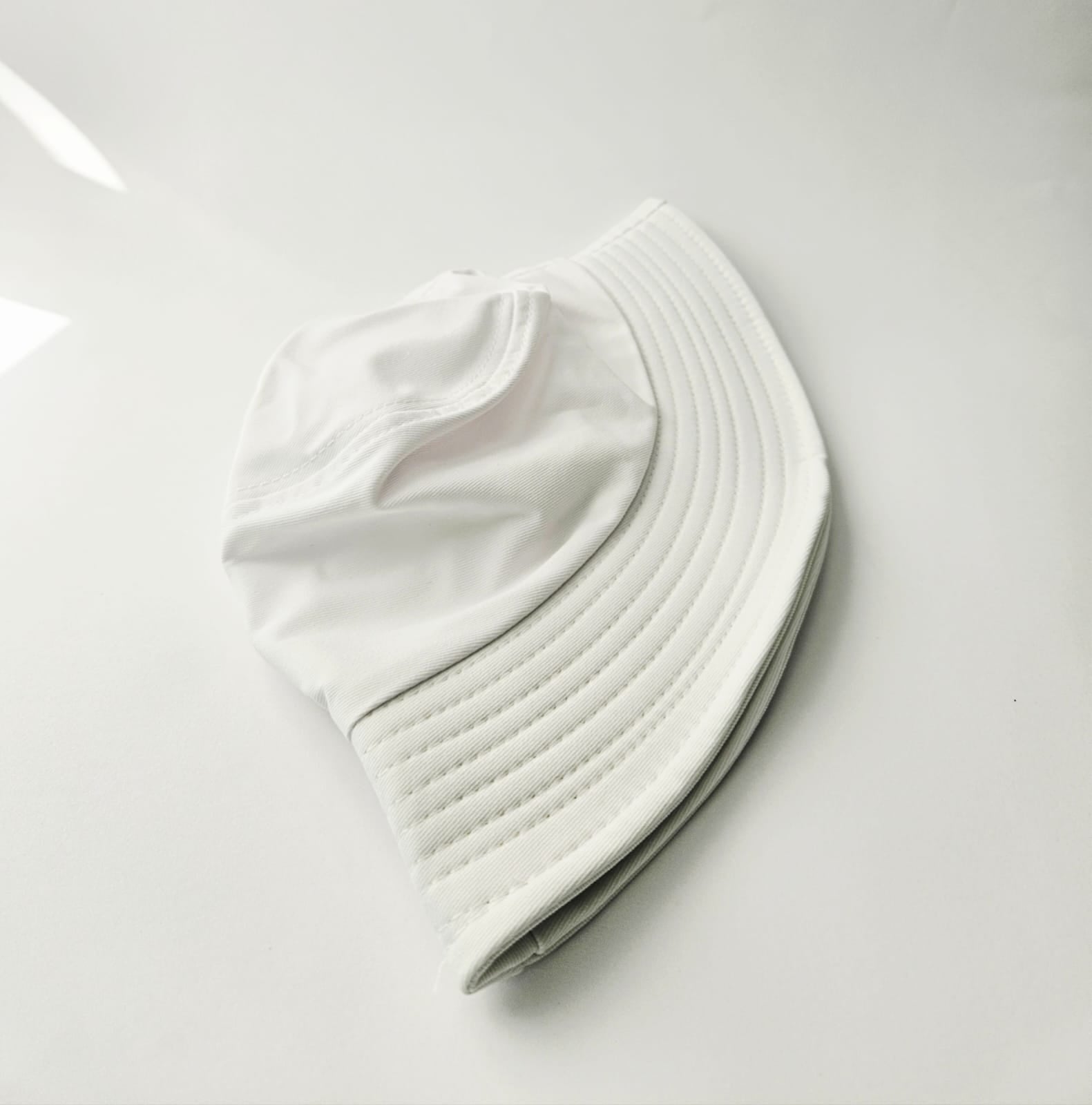 White bucket hat on a light gray background