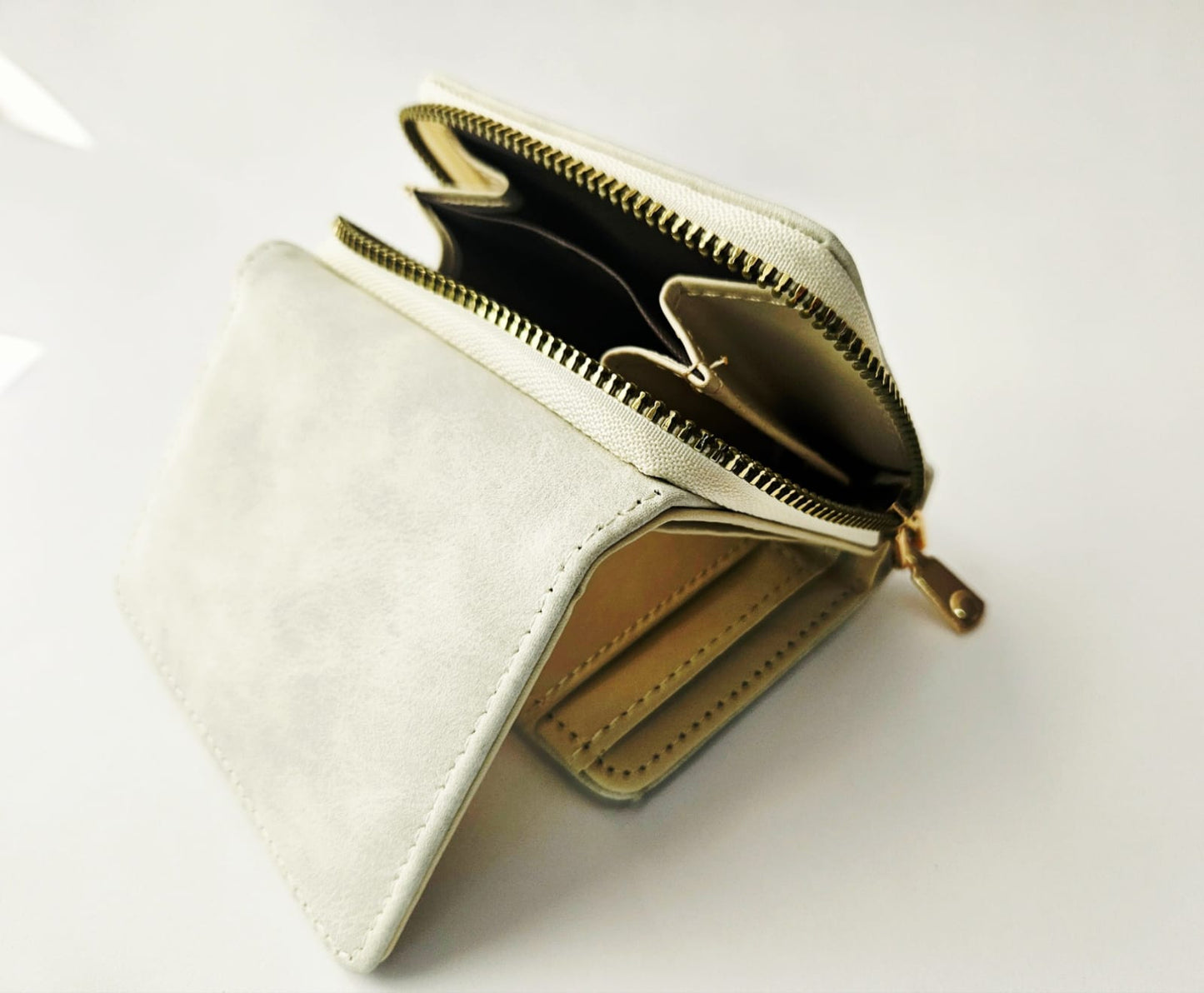 White wallet with gold zipper on a white background