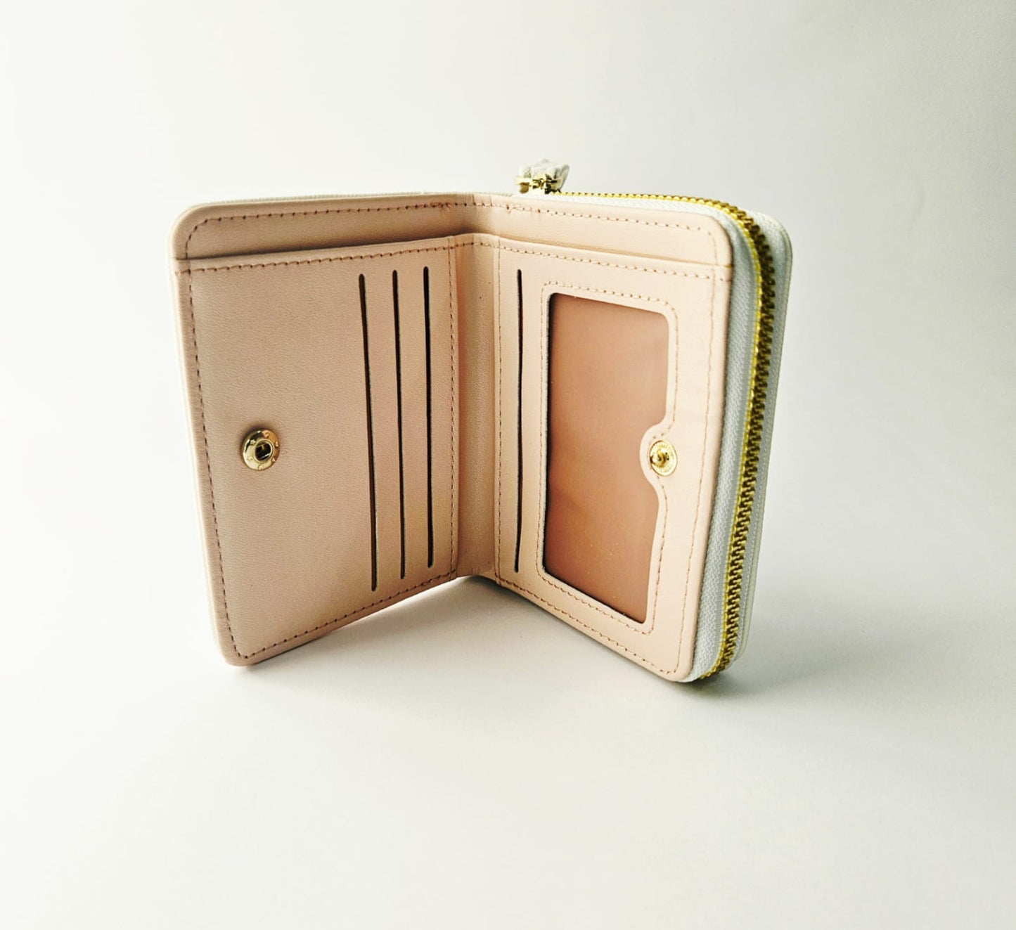 Light Pink inside wallet with gold accents on a light gray background